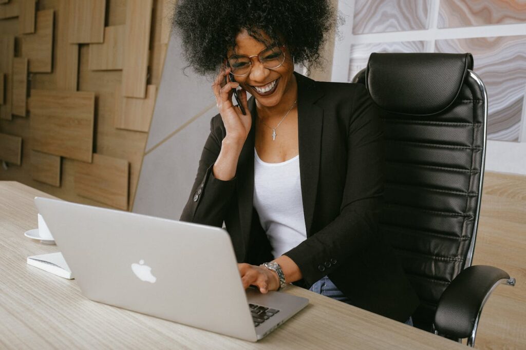 A sales professional at a desk talks by phone with a LinkedIn connection