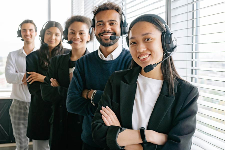 A successful outbound sales team smiling confidently