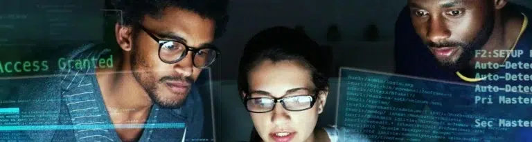 Three individuals engrossed in IT Lead Generation Services, attentively examining a computer screen.