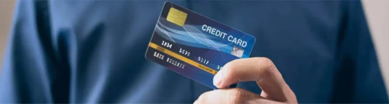 A man holding a credit card, symbolizing purchasing power, signifies the connection to purchasing lead lists.