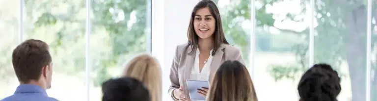 A woman presenting to a group.