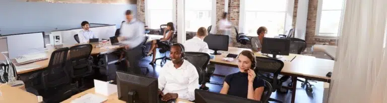 Office workers engaged in sales development rep outsourcing.