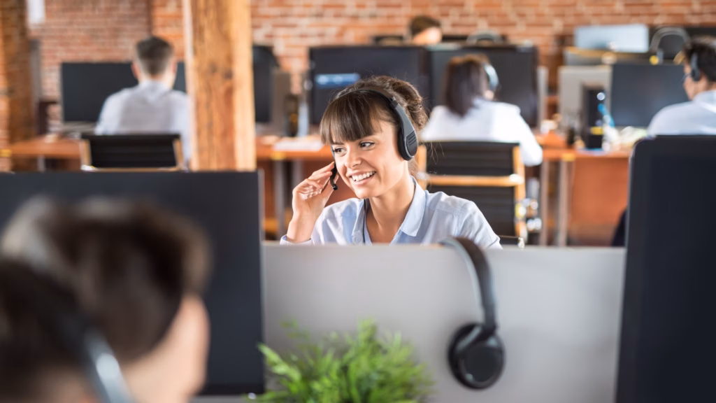 A call center team member smiles and appears confident