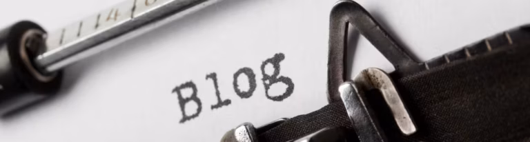 Typewriter typing blog; outsource blog writing focus.