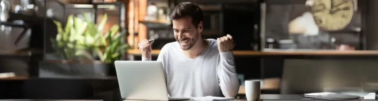 Excited person using a laptop for list builder success.
