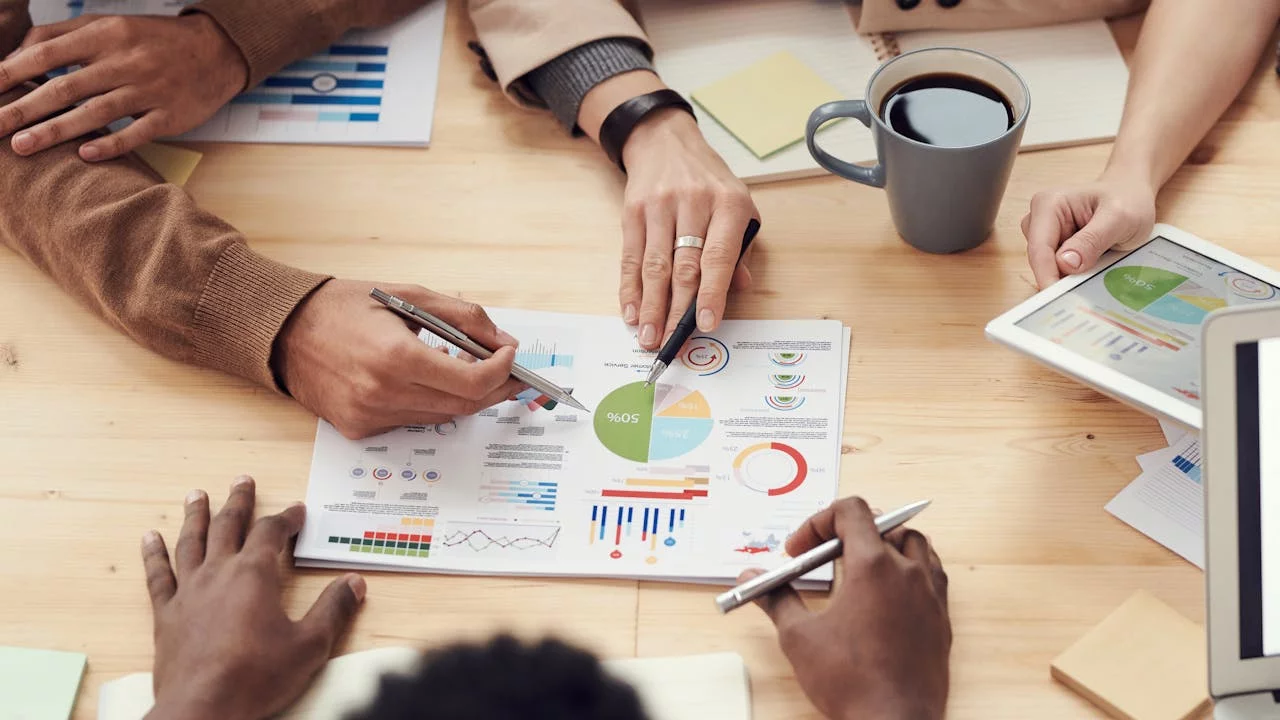 A business sales team reviewing their lead gen vs. demand gen strategy