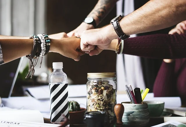 An SDR team bumps fists to celebrate overcoming sales challenges