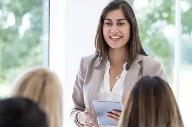 A woman presenting to a group.