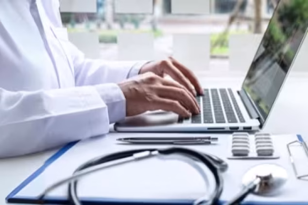Doctor on a laptop, getting SEO services for healthcare