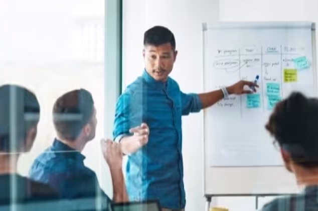 Employees having a meeting about the benefits of SEO for IT companies.