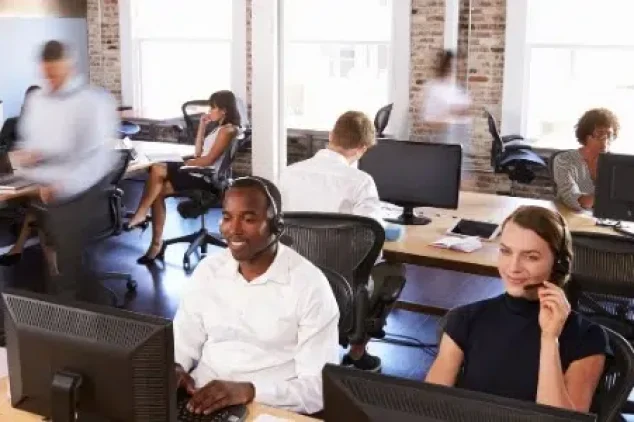 Office workers engaged in sales development rep outsourcing.
