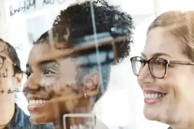 Team discussing the best time to send cold emails.