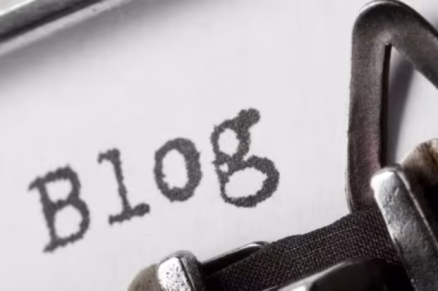 Typewriter typing blog; outsource blog writing focus.