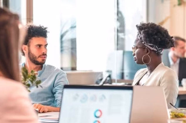 Workmates discussing importance of SEO agency for small business.