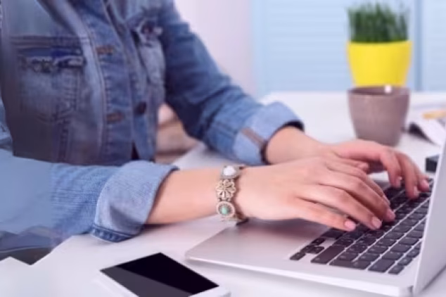 Writing SEO-optimized blog posts on laptop.