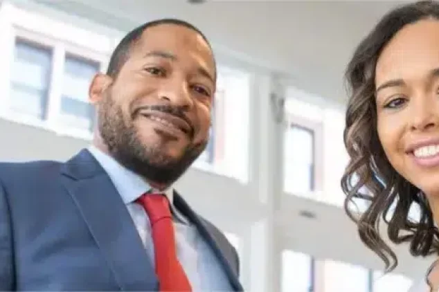 Two sales team members smile after a successful sales meeting